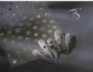 Macro shot of silver snowflake nail stickers TL-30 with metallic star accents and gemstone