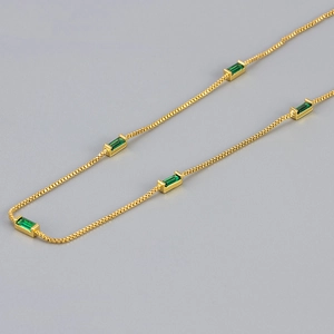 Minimalist gold necklace with five emerald green rectangular zircons on box chain