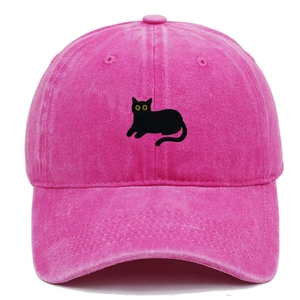 Close-up of black cat embroidery on distressed pink washed cotton baseball cap