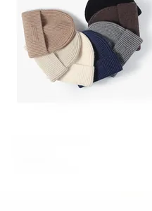 Macro view of six various winter knit beanies showing ribbed texture and soft fabric
