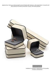 Cream jewelry box set with dark grey velvet interior for rings and necklaces