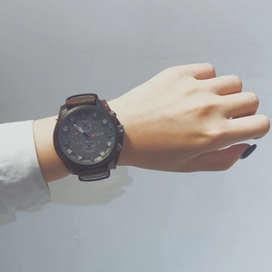 Men's sport watch featuring a black oversized dial with brown leather strap