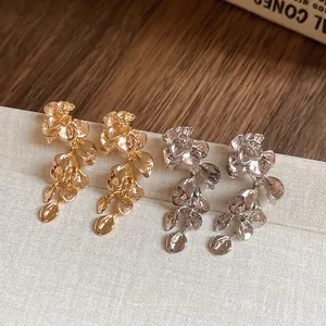 Elegant floral tassel earrings in gold and silver finish with textured metallic details