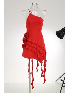 Detail of red one-shoulder dress featuring 3D roses and ruffled hem with long tassels