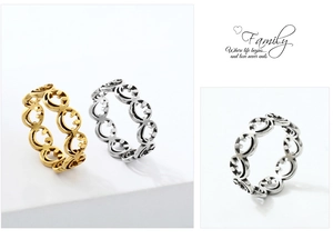 Close-up of gold and silver stainless steel rings with laser-cut hollow smiley face