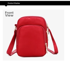 Detail view of red nylon crossbody bag showing gold zippers and multi-pocket layout