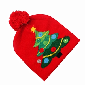 Detail of red knit Christmas hat with LED tree pattern and ON/OFF switch button