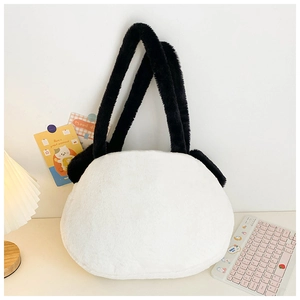 Close-up of a large white plush panda tote bag on a cozy desk with soft lighting