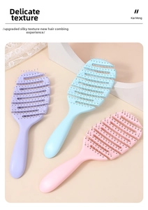 Close-up of three colorful vented hair brushes for volumizing and scalp massage