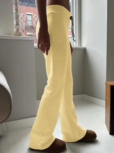 Women's pale yellow fleece flared yoga pants with adjustable drawstring waist and side view
