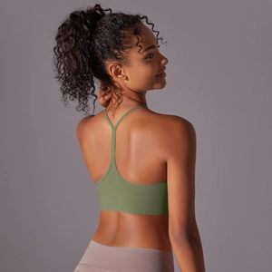 Close-up of olive green racerback sports bra with skinny straps and Y-back detail