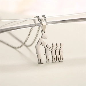 Macro shot of a silver stainless steel pendant featuring a mother and four children silhouette