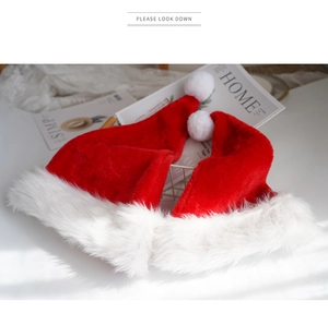 Set of two red plush Christmas hats with fluffy white faux fur trim and pom-poms
