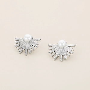 Macro view of silver stainless steel earrings featuring radial fan design and white pearl