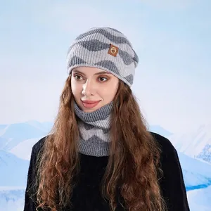 Winter two-piece set with wave knit hat and neck warmer against a snowy background