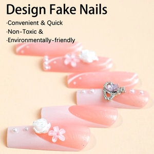 Extra long French press-on nails with pink gradient, floral accents and 3D crown jewelry