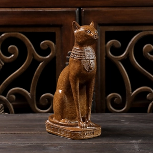 Vintage wood-grain resin Egyptian Bastet cat statue on dark wooden surface for home decor