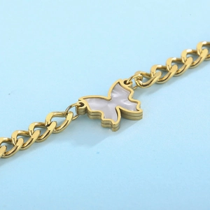 Golden titanium NK chain necklace with white shell butterfly pendant on blue background