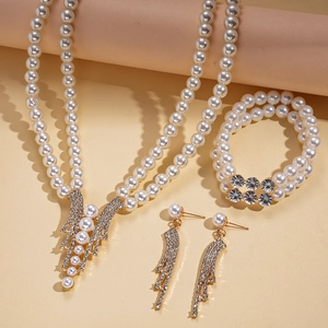 Detailed close-up of a luxury three-piece jewelry set with pearls and diamonds