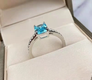 Minimalist silver open ring with square blue zircon gemstone and side diamond accents