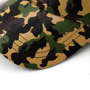 Detailed macro view of camo PU leather visor with reinforced stitching on baseball cap