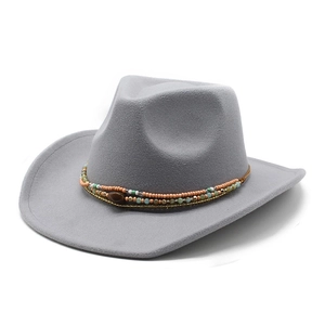 Grey western cowboy felt hat with ethnic beads and metal chain on white background
