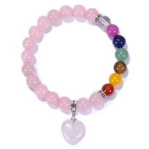 Detail of 8mm pink quartz beads with chakra stones and heart pendant on a bracelet