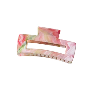 Detail of square marble pattern hair claw clip with pink and green acetate textures