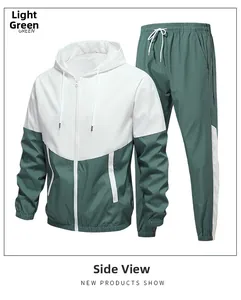 Detail of light green hooded sports jacket and pants with contrast panels and zippers