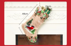 Detailed view of printed Christmas stocking with bird and tree patterns and dimensions