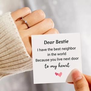 Silver heart ring detail with a sentimental bestie gift card in soft lighting