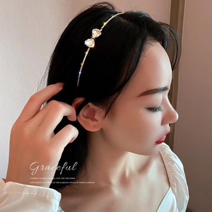 Elegant thin silver metal headband with shimmering rhinestone bows for a stylish hair look