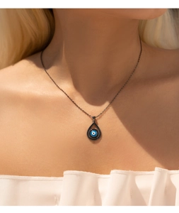 Close-up of S925 silver necklace with turquoise devil eye pendant and black diamonds