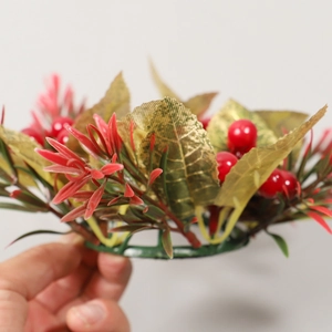 Christmas pine cone candle ring with red berries and golden leaves for table decor