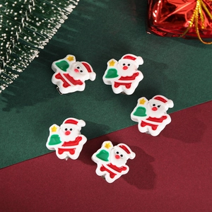 Close-up of five cartoon Santa Claus hair clips with festive green pine and gift box decor
