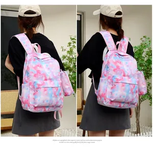 Detail of pink and blue tie-dye star backpack with matching mini pouch and straps