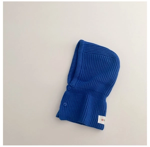 Detailed knit texture of bright blue baby balaclava with two matching buttons