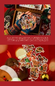 Close-up of vintage Christmas party night stickers for scrapbooking with gold foil detail