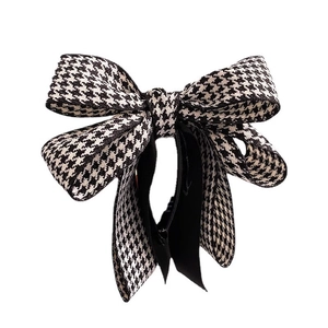 Elegant houndstooth bow hair clip with double-layer fabric design on white background
