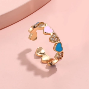 Dettaglio dell'anello aperto dorato con cuori in smalto e cristalli incastonati