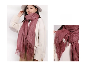 Detail of burgundy cashmere-like scarf showing soft texture tassels and sewn-on label