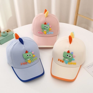 Detailed view of kids' cotton dinosaur baseball caps in pink, blue and beige colors