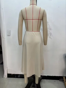 Detail view of cream midi skirt showing soft draped fabric and elegant A-line back silhouette