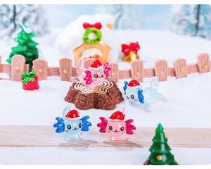 Miniature Christmas axolotl figurines with Santa hats in a snowy resin landscape