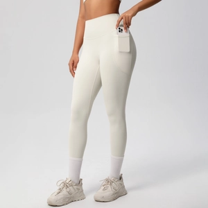 Close-up of high-waisted yoga pants featuring functional side phone pockets and soft fabric