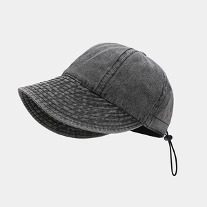Detail of grey washed denim sun hat featuring adjustable drawstring and texture