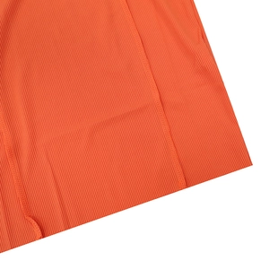Detailed macro view of orange ribbed knit fabric with professional double stitching