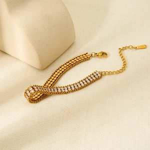Close-up of 18K gold-plated double-row bracelet with pavé-set zircons and lobster clasp