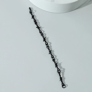 Punk style black barbed wire metal bracelet for men and women on a grey background