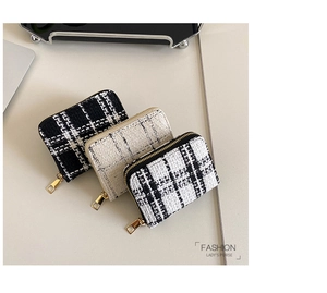 Close-up of stylish tweed coin purses with woven texture and premium gold zippers